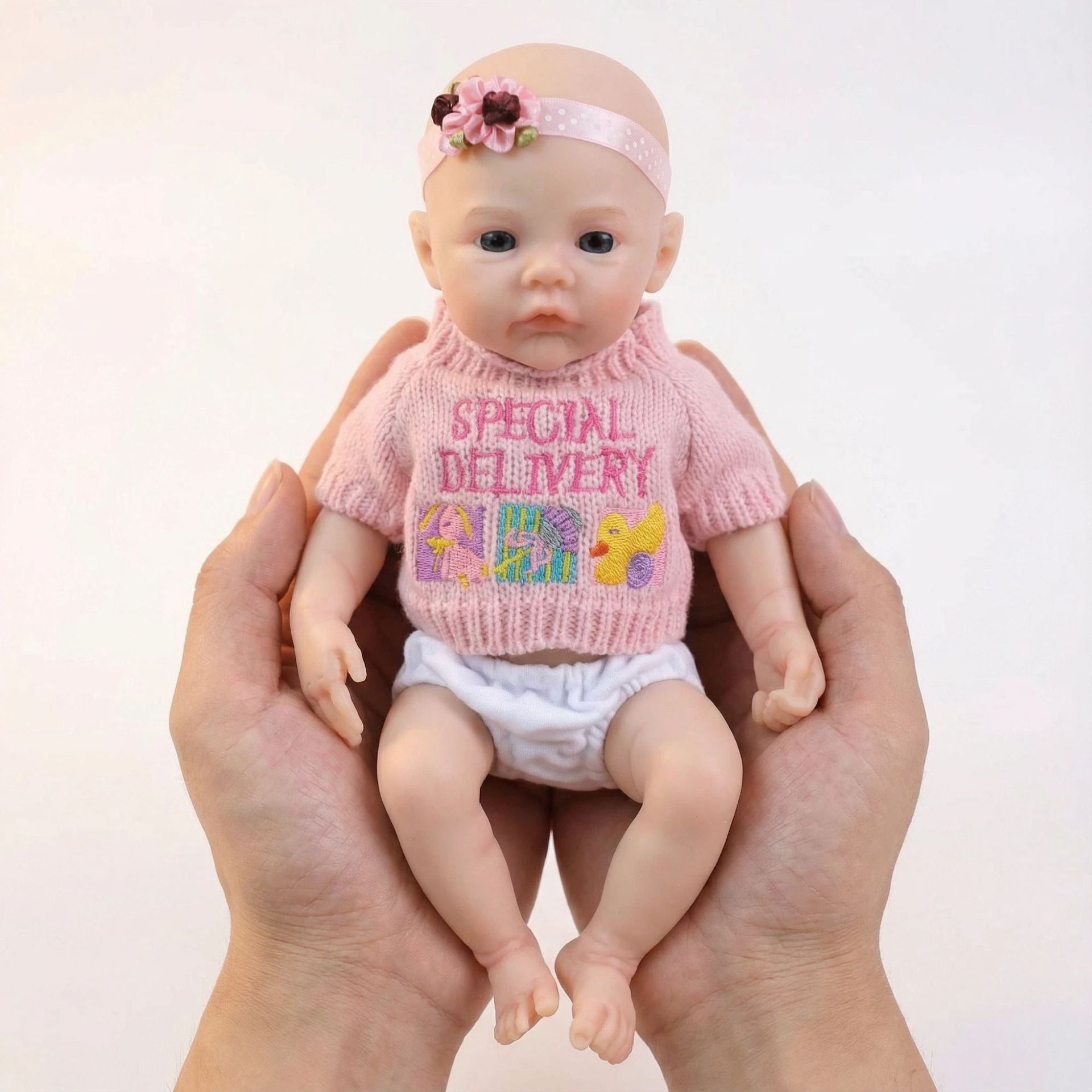 12 inch pink sweater top with meadow solid silicone reincarnation doll as a Christmas gift for children