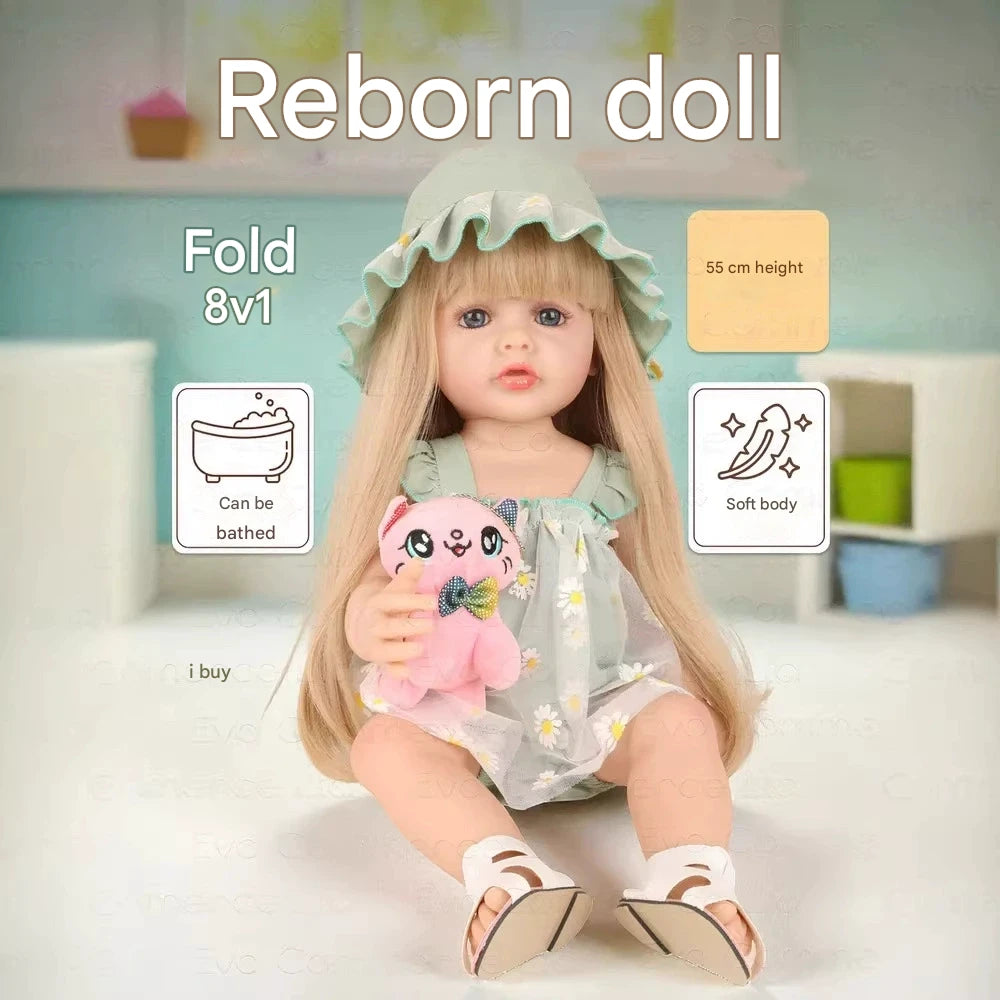 Reborn doll with a pink plush toy, sitting on a white surface with a blurred background.